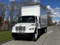 White 2016 Freightliner M2 106 box truck with a shiny silver cargo area and a black front grille parked on a road