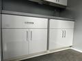 A 40-foot custom climate-controlled storage container with sleek white cabinetry and a gray countertop featuring a modern faucet