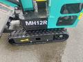 A 2024 AGT Industrial MH12R Mini Excavator featuring a compact design and caterpillar tracks for enhanced mobility