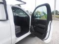A 2015 Chevrolet Silverado 1500 with an open driver's side door showing the interior and seating area