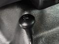 A black four-wheel drive control knob labeled with "4H" and "4L" mounted on a textured surface