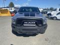2021 RAM 1500 pickup truck with a prominent front grille featuring the RAM logo and a black hood stripe