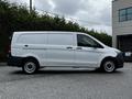 A 2023 Mercedes-Benz Metris van in white with a black lower trim viewed from the side showcasing its sleek design and commercial utility features