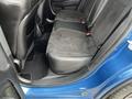The interior of a 2022 Dodge Charger showing the back seat with black leather and suede upholstery