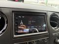 A dashboard display of a 2015 Ford F-350 SD showing a radio station tuned to 103.50 MHz with the label "Adult Hits" and various controls below the screen
