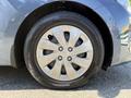 Close-up of a silver wheel and tire of a 2018 Kia Rio5 showcasing the six-spoke alloy rim and tire tread pattern