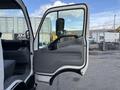A 2014 Hino 195 truck door opened wide revealing the interior space with a gray panel and seat visible