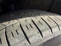 Close-up of a worn tire tread showcasing various patterns and grooves on a 2021 Toyota C-HR tire