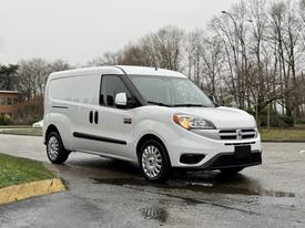 A white 2017 RAM ProMaster City van is parked with a clean exterior featuring sliding side doors and five-spoke wheels