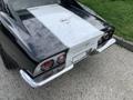 A black and white 1972 Chevrolet Corvette with distinctive round red taillights and a sleek rear design