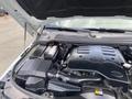 Engine compartment of a 2006 Land Rover LR3 showing the engine cover battery and various components