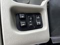Controls on the dashboard of a 2011 International 4400 including mirror adjustment panel light controls and parking light switch