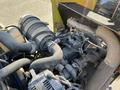 Close-up of the engine of a 2010 Kubota F3990 showing various hoses wires and components with some dust and dirt accumulation