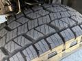 Close-up of a rugged tire tread on a 2014 Ford F-250 SD showcasing deep grooves and patterned design for traction on various surfaces
