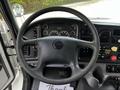 Steering wheel and dashboard of a 2010 Freightliner M2 106 with various gauges and controls visible