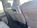 2017 Ford F-150 back seat interior with grey fabric upholstery and built-in cup holder in the center armrest