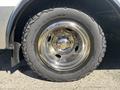 Close-up of a shiny chrome wheel rim with a rugged tire on a 2017 Chevrolet Express van