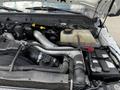 Engine compartment of a 2016 Ford F-550 showcasing various components including the battery coolant reservoir and air intake system