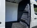 A 2022 Mercedes-Benz Sprinter with an open cargo area showing a blank white interior and a dark black floor