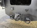 Close-up of the hitch on a 2011 International 4300 with a metal coupling device and two attachment points on the underside