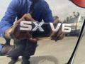 A 2015 Kia Sorento badge displaying the letters SX V6