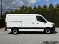 A 2020 Mercedes-Benz Sprinter van in white with a black stripe along the bottom, viewed from the side with closed rear doors and no visible windows in the cargo area