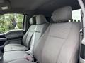 The interior of a 2018 Ford F-150 showing two front seats with gray fabric upholstery and adjustable headrests