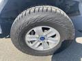 A close-up of a 2017 Ford F-150 wheel featuring a silver alloy rim and an all-terrain tire with a distinctive tread pattern