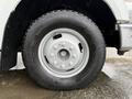 A close-up of a silver wheel on a 2008 Ford F-350 featuring distinct tread patterns and multiple lug nuts