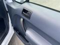 Interior door handle of a 2013 Ford Transit Connect with textured panel and speaker visible