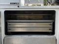 A 2016 Ford F-550 service truck with open compartments revealing multiple metal drawers for storage and organization