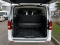 A 2018 Mercedes-Benz Metris with a spacious rear cargo area featuring black upholstery and two rows of seats facing forward