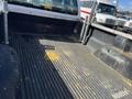 A 2013 Ford F-250 SD with a rugged bed liner showing signs of wear and scattered debris in the truck bed