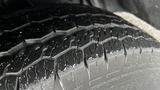 Close-up of a wet tire tread on a 2012 Ford Transit showing intricate patterns and grooves