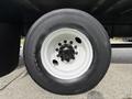 White wheel rim with black tire mounted on a 2017 Hino 338 truck tire assembly visible from the side