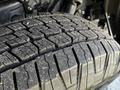 Close-up of a tire tread on a 2023 Toyota Tundra showing detailed patterns and textures with some dirt visible on the surface