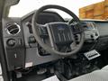 Interior view of a 2016 Ford F-550 showing the steering wheel dashboard and control panel with various buttons and dials