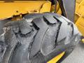 Close-up of a tire tread on a 2011 John Deere 310SJ 4x4 Wheel Loader Extended Hoe 4 in 1 showcasing deep grooves and rugged texture