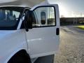 A white 2017 Chevrolet Express van with the driver's side door open showcasing the interior and dashboard area