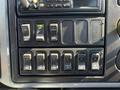 Dashboard switches and controls of a 2007 International 7300 with various buttons labeled for different functions