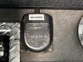 A silver and black air horn with a textured surface mounted on a control panel labeled AIR HORNS