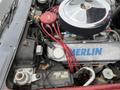 Engine compartment of a 1970 Chevrolet Corvette featuring a polished chrome air cleaner red spark plug wires and various engine components