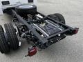 A 2024 Ford F-550 chassis with large tires and a visible fuel tank engine compartment and rear axle assembly