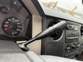 Close-up of a 2008 Ford F-250 SD interior showing the gear shift lever and dashboard gauges