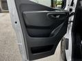 The image shows the interior door panel of a 2023 Mercedes-Benz Sprinter featuring a sleek design with a handle and storage compartment.