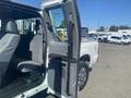2014 Ford F-250 SD with an open passenger door revealing the interior with a fabric seat and console