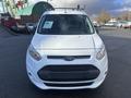 A 2017 Ford Transit Connect seen from the front with a white exterior and a black grille