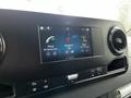 A digital display screen in a 2019 Mercedes-Benz Sprinter showing options for phone connectivity navigation and radio stations