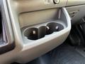 A close-up view of the cup holders in the front compartment of a 2023 Ford Transit