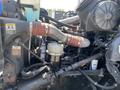 Close-up of the engine components of a 2008 Peterbilt 340 featuring pipes, hoses, and a fuel filter